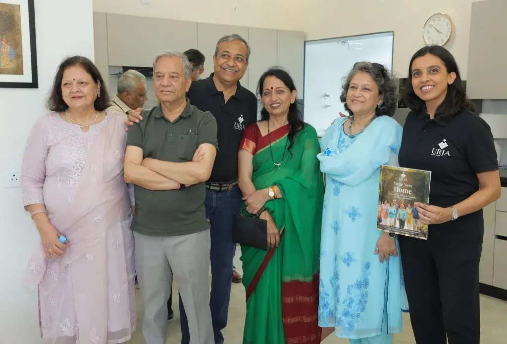 Happy senior residents and families exploring CHL Urja luxury senior living community in Indore